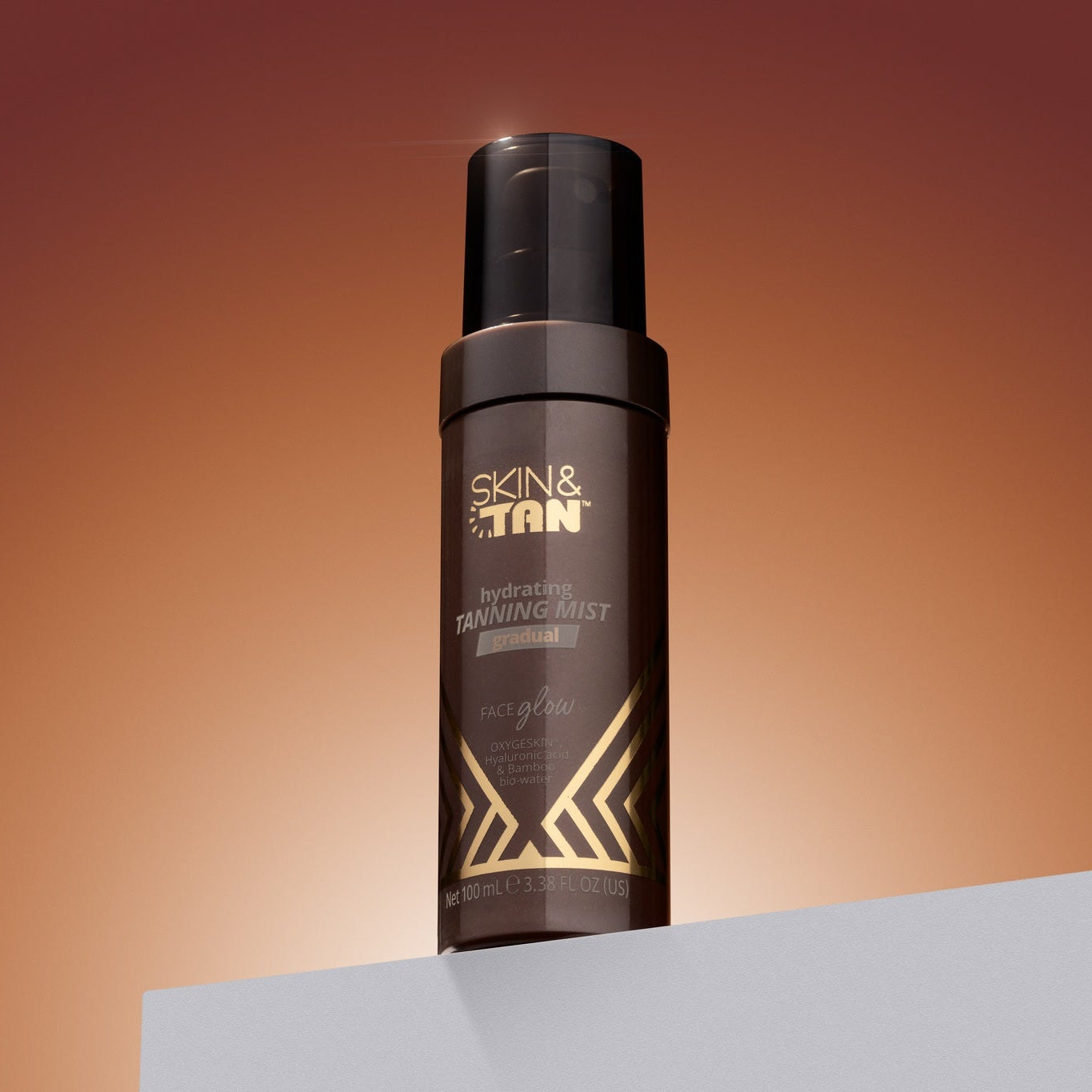 Face Glow Hydrating Tanning Mist on a warm studio set